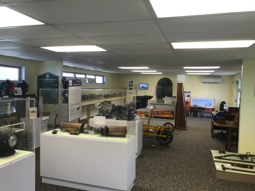 A museum interior featuring exhibits of machinery and historical artifacts, with display cases and informational panels.