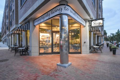 Exterior view of a brunch restaurant with outdoor seating, large windows, and a sign reading "Swing Bruncherie."