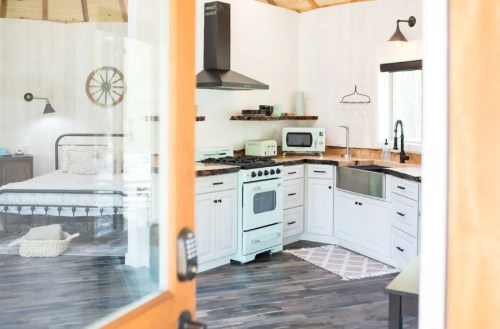 Cozy interior of a modern kitchen and bedroom with wooden accents and natural light.