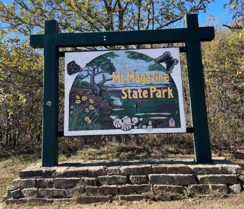 Sign for Mt. Magazine State Park featuring a colorful illustration of nature and wildlife.