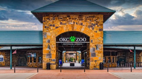 Entrance to Okeechobee Zoo and Botanical Garden, featuring a stone archway and welcoming signage.
