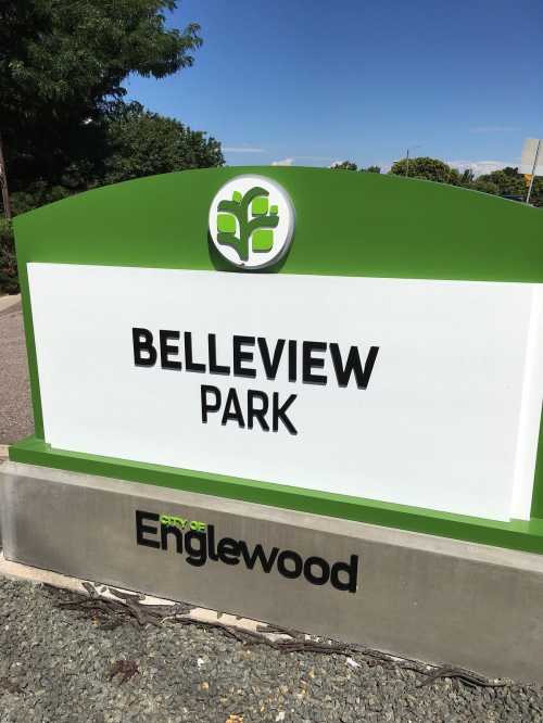 Sign for Belleview Park in Englewood, featuring a green design and tree logo.