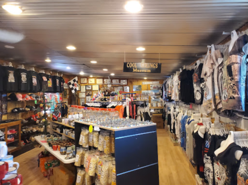 Interior of a gift shop featuring various merchandise, including clothing, souvenirs, and collectibles on display.