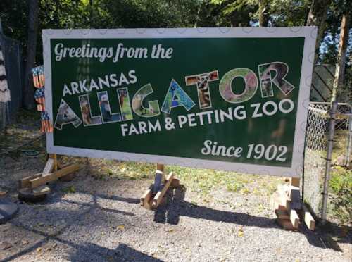 Sign for Arkansas Alligator Farm & Petting Zoo, featuring colorful letters and the text "Since 1902."