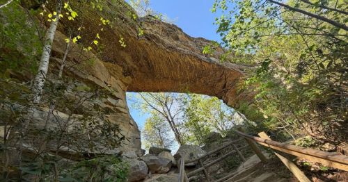 Sandstone rock formation in Kentucky resembling a natural arch.