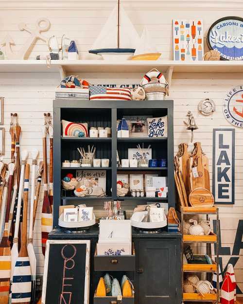 A cozy display of nautical-themed decor and gifts, featuring shelves with various items and decorative boat paddles.