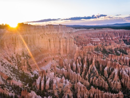 Sunrise over Bryce Canyon, highlighting the unique rock formations and vibrant colors of the landscape.