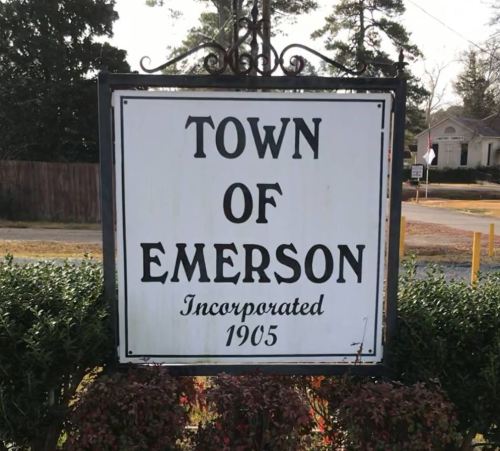 Sign for the Town of Emerson, incorporated in 1905, surrounded by greenery.