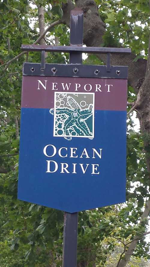 Sign for Ocean Drive in Newport, featuring a decorative design and green and blue colors.