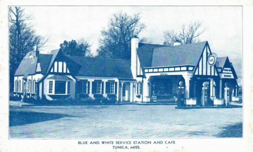 Historic blue and white service station and café in Tunica, Mississippi, featuring vintage gas pumps and a charming design.
