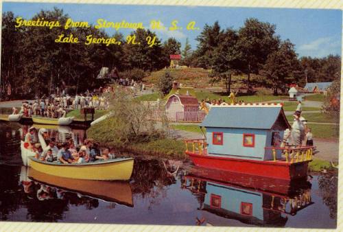 A vintage postcard showing colorful boats on a lake with people enjoying a scenic park at Storytown, Lake George, NY.