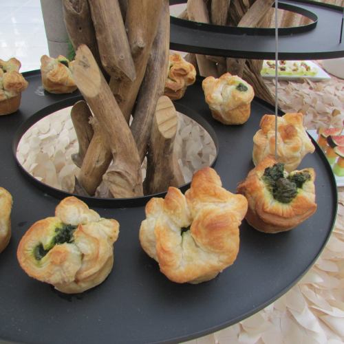 A decorative display featuring baked pastries arranged on a circular stand with wooden accents.