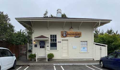 A charming, light-colored building with a sign reading "Waterfront Depot" and a welcoming entrance.