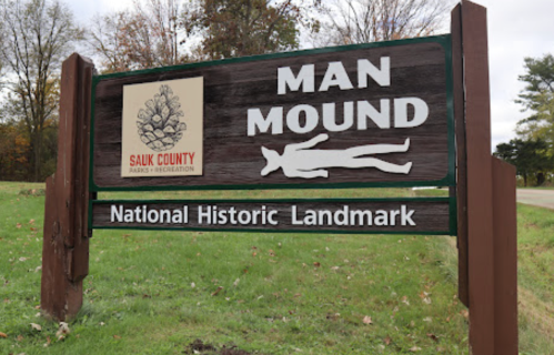 Sign for Man Mound, a National Historic Landmark in Sauk County, featuring a silhouette of a figure and a tree logo.