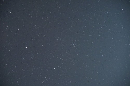 A clear night sky filled with numerous stars, creating a serene and expansive cosmic view.
