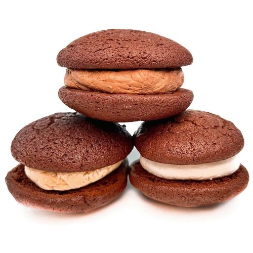 Four chocolate whoopie pies stacked, two filled with chocolate ice cream and two with vanilla ice cream.