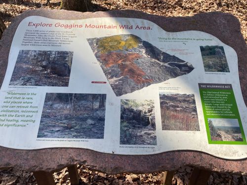 Informational sign about Goggins Mountain Wild Area, featuring maps and text on wilderness conservation and local ecology.