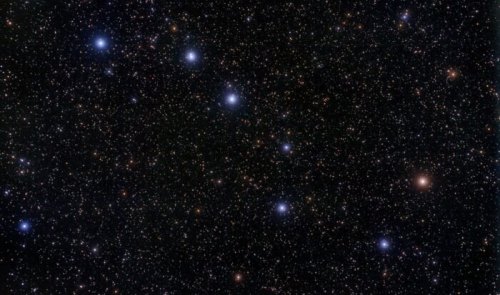 A vast night sky filled with countless stars, some shining brightly against a dark backdrop of space.