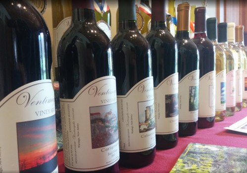 A row of wine bottles with labels from Ventimiglia Vineyard, showcasing various red and white wines.