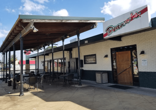 Exterior of Dean's restaurant featuring a covered patio and outdoor seating area.