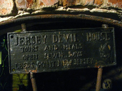 Sign for Jersey Devil House, advertising tours and meals, located in Leeds Point, New Jersey, open seven days a week.