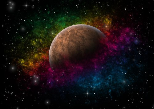 A colorful cosmic scene featuring a planet surrounded by vibrant nebulae and stars against a dark background.
