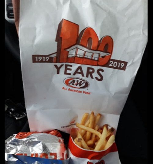 A&W bag celebrating 100 years, with fries and a burger visible beside it.