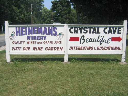 Sign for Heineman's Winery and Crystal Cave, promoting wine garden and educational cave tours.