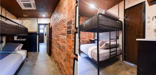 A cozy room with a bunk bed, exposed brick walls, and a small kitchenette area.