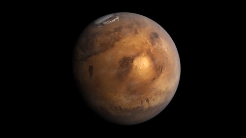A detailed view of Mars, showcasing its reddish surface and polar ice caps against a black background.