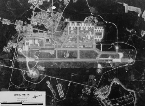 Aerial view of Loring Air Force Base in Maine, showing runways, buildings, and surrounding landscape.