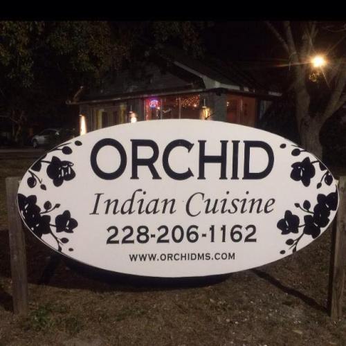 Sign for "Orchid Indian Cuisine" featuring a floral design, phone number, and website.