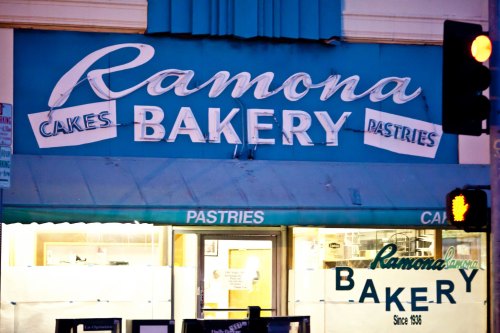 Sign for Ramona Bakery, featuring "Cakes" and "Pastries," with a vintage design and establishment date of 1936.
