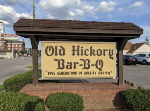 Sign for Old Hickory Bar-B-Q, featuring the text "Five Generations of Quality Bar-B-Q" against a blue sky backdrop.