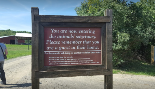 Sign at an animal sanctuary outlining visitor rules and reminding guests to respect the animals' home.