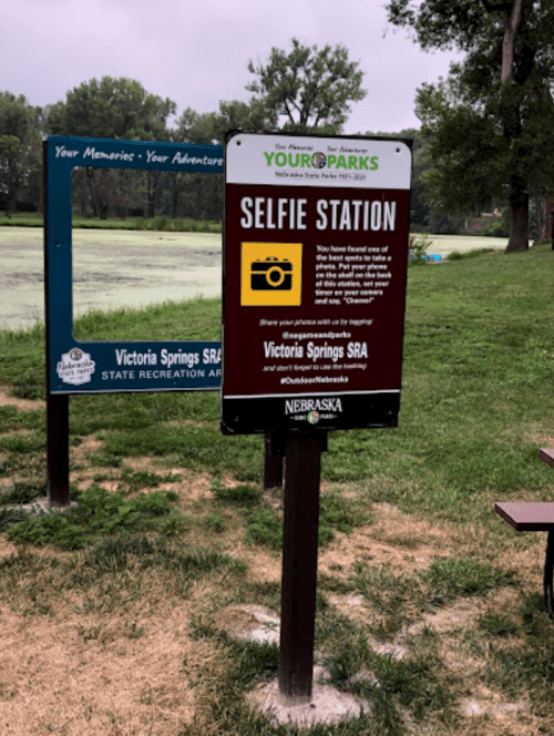 Sign for a selfie station at Victoria Springs State Recreation Area, encouraging visitors to take and share photos.