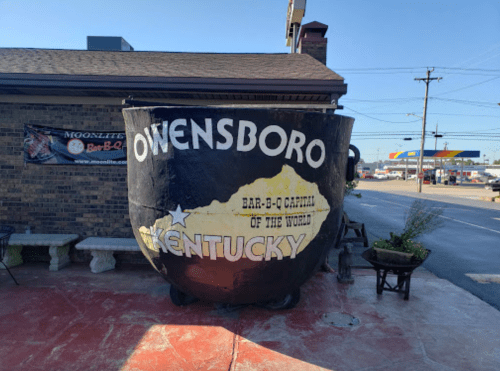 A large, painted bowl with "Owensboro, Kentucky" and "Bar-B-Q Capital of the World" on a building exterior.
