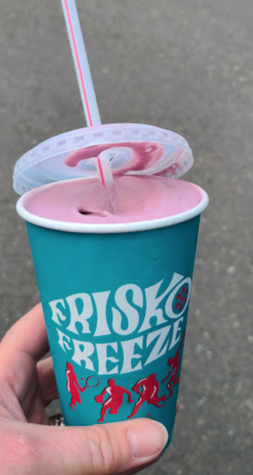 A hand holding a teal cup with a lid and straw, featuring the logo "FRISKO BREEZE" in white and red.