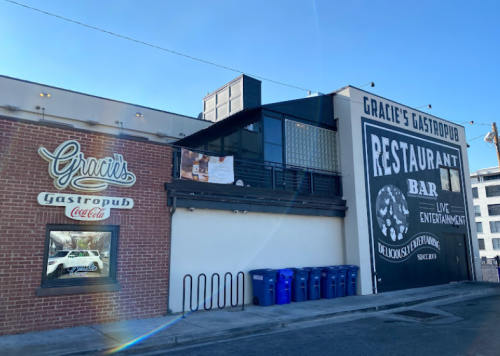 Exterior view of Gracie's Gastropub, featuring a brick facade and a large sign for the restaurant and bar.
