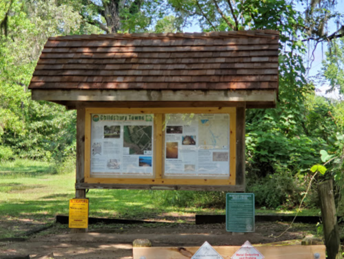 Information kiosk with maps and details about Child's Tarry Towns, surrounded by greenery.