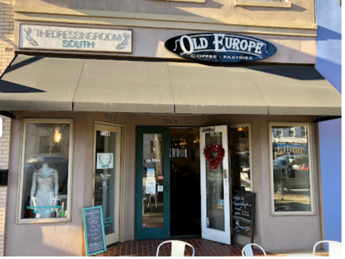 Exterior of Old Europe Coffee & Pastries, featuring a welcoming entrance and a heart decoration on the door.