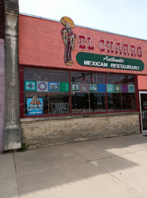 Exterior of El Charro Mexican Restaurant, featuring colorful signage and an "Open" sign in the window.