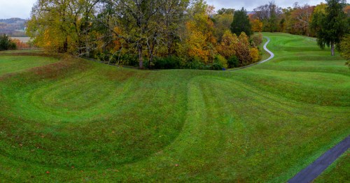 Aerial view of the sweeping, grassy coils of Serpent Mound in Peebles, Ohio.