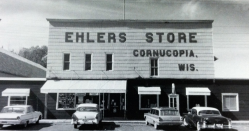 Black and white photo of Ehlers Store in Cornucopia, Wisconsin, featuring vintage cars parked outside.