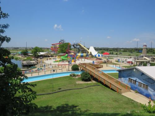 A vibrant water park featuring slides, pools, and colorful attractions under a clear blue sky.