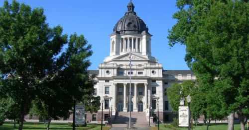 South Dakota State Capitol set against a bright blue sky.
