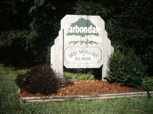 Welcome sign for Carbondale, Illinois, highlighting it as the "Best Small City in Illinois" with a population of 27,033.