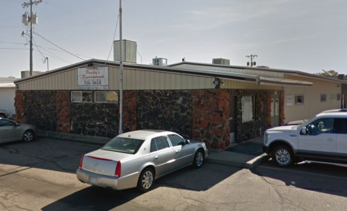 Exterior view of Becky's Restaurant, featuring a stone facade and parked cars in front.