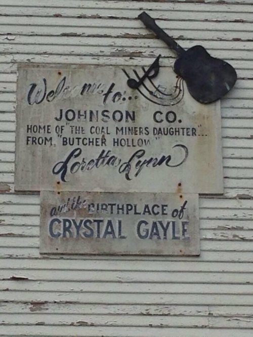 Sign welcoming visitors to Johnson County, highlighting Loretta Lynn and Crystal Gayle's birthplace.