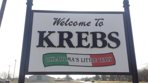 Welcome sign for Krebs, Oklahoma, featuring the phrase "Oklahoma's Little Italy" with a green, white, and red banner.